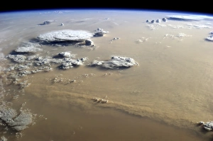 View of a dust storm that stretches across the sand seas of the Sahara Desert View of a dust storm that stretches across the sand seas of the Sahara Desert