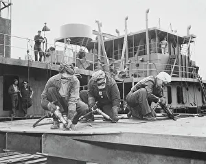 Three women chippers working in a shipbuilding shipyard Three women chippers working in a shipbuilding shipyard