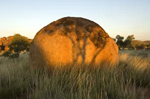 The Devils Marbles, a series of sandstone rocks perched at seemingly impossible angles The Devils Marbles, a series of sandstone rocks perched at seemingly impossible angles