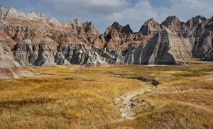 Eroded badlands and prairie grasses, Badlands National Park, South Dakota, USA. August Eroded badlands and prairie grasses, Badlands National Park, South Dakota, USA. August