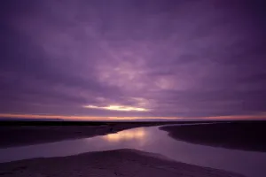 Estuarine river inlet running across mudflats at dawn, Morecambe Bay, Cumbria, England Estuarine river inlet running across mudflats at dawn, Morecambe Bay, Cumbria, England
