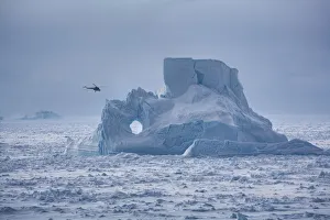Helicopter from Russian icebreaker Kapitan Khlebnikov flies past iceberg in the Weddell Helicopter from Russian icebreaker Kapitan Khlebnikov flies past iceberg in the Weddell