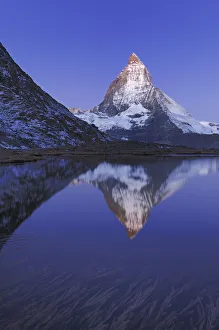 Matterhorn at sunrise in autumn with reflection in the Riffelsee. Zermatt, Valais Matterhorn at sunrise in autumn with reflection in the Riffelsee. Zermatt, Valais