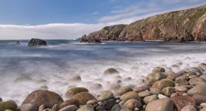Pebbles on shoreline, cliffs along coast beyond. Bloody Foreland, Knockfola Pebbles on shoreline, cliffs along coast beyond. Bloody Foreland, Knockfola