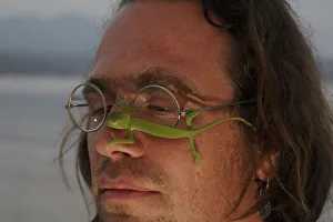Photographer, Christian Ziegler, with a juvenile African chameleon (Chamaeleo africanus) Photographer, Christian Ziegler, with a juvenile African chameleon (Chamaeleo africanus)