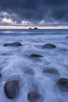 Porth Nanven at dusk, stormy sky and rising tide, The Cot Valley, St Just, Cornwall, UK Porth Nanven at dusk, stormy sky and rising tide, The Cot Valley, St Just, Cornwall, UK