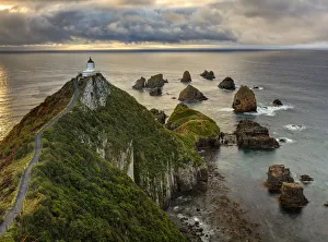 RF- Nugget Point (Ka Tokata) lighthouse at sunrise, rain clouds sweeping in from RF- Nugget Point (Ka Tokata) lighthouse at sunrise, rain clouds sweeping in from