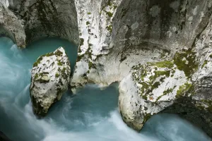 River Soca flowing through Velika korita with erosion in rock visible River Soca flowing through Velika korita with erosion in rock visible