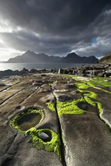 Rocky shoreline, Loch Scavaig and view to Cuillin mountians, Isle of Skye, Scotland, UK, April Rocky shoreline, Loch Scavaig and view to Cuillin mountians, Isle of Skye, Scotland, UK, April