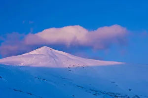A snowy mountain peak lit by low crepuscular light before sunset. Ordesa National Park A snowy mountain peak lit by low crepuscular light before sunset. Ordesa National Park