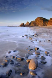 Tide washing over pebbles at Sandymouth bay, north Cornwall, UK. January 2009 Tide washing over pebbles at Sandymouth bay, north Cornwall, UK. January 2009