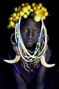 Young girl wearing traditional headdress, Mursi tribe, Mago National Park. Omo Valley Young girl wearing traditional headdress, Mursi tribe, Mago National Park. Omo Valley