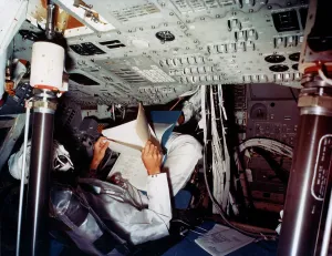 Vintage Space Exploration Prints: An astronaut inside a NASA Command Module, 1970s. Artist: NASA