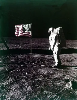 Buzz Aldrin stands next to the American flag on the surface of the Moon, July 1969 Buzz Aldrin stands next to the American flag on the surface of the Moon, July 1969