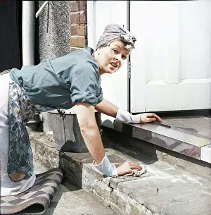 Colorised Black And White Print Prints: Charlady scrubbing steps, c1955. Creator: Arthur Charles Kirby Ware