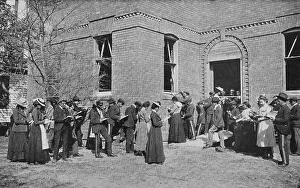 Print of a group of children learning arithmetic outdoors in 1904