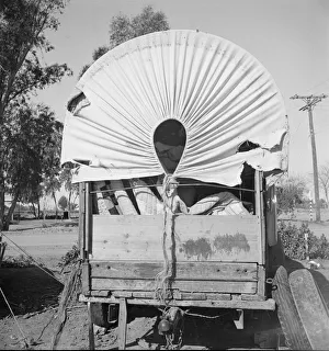 Covered wagon, migratory carrot puller's camp, near Holtville, Imperial Valley, 1939. Creator: Dorothea Lange Covered wagon, migratory carrot puller's camp, near Holtville, Imperial Valley, 1939. Creator: Dorothea Lange