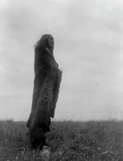 Prints of Crying to the spirits, c1908. Hidatsa Indian (Yellow Owl?) standing in field, full-length, wearing fur robe, facing right Edward Curtis Prints: Crying to the Spirits Print, Hidatsa Indian, c1908
