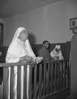 A disciple of the St. Martin's Spiritual Church praying before the altar... Washington, D.C. 1942 A disciple of the St. Martin's Spiritual Church praying before the altar... Washington, D.C. 1942
