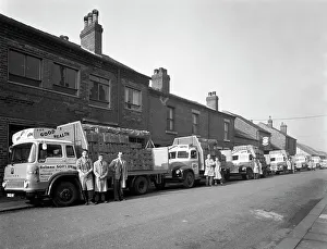 Prints of Fleet of soft drinks delivery lorries, Mexborough, South Yorkshire, 1961. The fleet of lorries with their newest Bedford TK at the front of the line up Street Art Prints: Fleet of Soft Drinks Delivery Lorries, Mexborough, 1961 Print