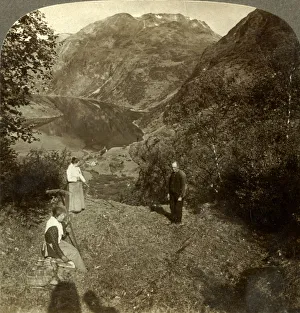 Haying on mountain shelf high above Marok village and mirror-clear Geirangerfjord Haying on mountain shelf high above Marok village and mirror-clear Geirangerfjord