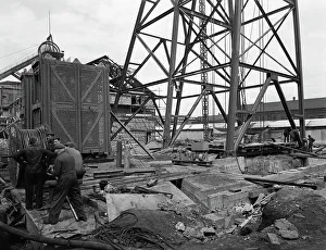 British Coal Industry Prints: Installing a cage at Hickleton Main pit, Thurnscoe, South Yorkshire, 1961. Artist