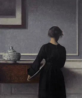 Interior with Young Woman from Behind. Artist: Hammershoi, Vilhelm (1864-1916) Interior with Young Woman from Behind. Artist: Hammershoi, Vilhelm (1864-1916)