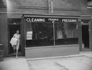 Possibly: A tailor in Frank's cleaning and pressing establishment checking... Washington, DC, 1942 Possibly: A tailor in Frank's cleaning and pressing establishment checking... Washington, DC, 1942