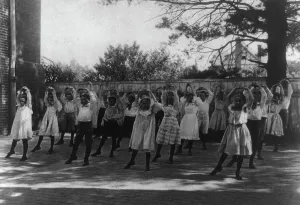 Physical Education History Prints: School children learning a dance in a school yard