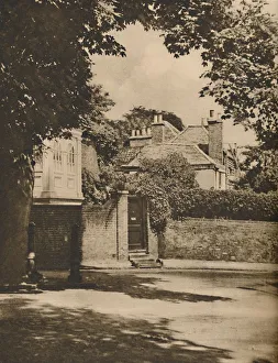 London Landscape Photography Prints: Sunlight and Shadow in a Winding Highgate Road, c1935. Creator: Paterson