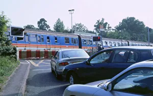 Road Transport Images Prints: Traffic queue at level crossing in Brockenhurst, Hampshire