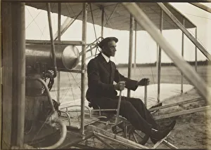 Early Aviation Images Prints: Wilbur Wright in the flyer, 1908. Creator: Anonymous