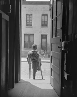 Young boy standing in the doorway of his home on Seaton Road... Washington, D.C, 1942. Creator: Gordon Parks Young boy standing in the doorway of his home on Seaton Road... Washington, D.C, 1942. Creator: Gordon Parks