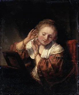 Young Woman trying on Earrings, 1657. Artist: Rembrandt Harmensz van Rijn Young Woman trying on Earrings, 1657. Artist: Rembrandt Harmensz van Rijn
