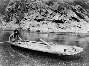 American Indian Heritage Prints: Yurok canoe on Trinity River, c1923. Creator: Edward Sheriff Curtis