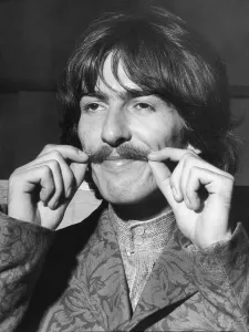Prints of George Harrison plays with his moustache Music Prints: George Harrison adjusts his moustache in EMI studio print