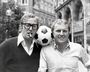 Prints of Michael Caine pictured with Bobby Moore in Leicester Square, London, to promote their film Escape to Victory United Kingdom Prints: Michael Caine and Bobby Moore Print