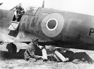 RAF ground crew loading air sea rescue equipment into the belly of a Spitfire RAF ground crew loading air sea rescue equipment into the belly of a Spitfire