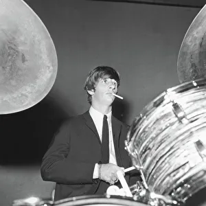 Ringo Starr smokes a cigarette at the drums as the Beatles perfo Ringo Starr smokes a cigarette at the drums as the Beatles perfo