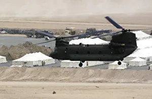 A Chinook helicopter from the Joint Helicopter Force, flying over the desert of A Chinook helicopter from the Joint Helicopter Force, flying over the desert of