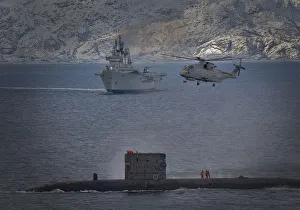 HMS Talent conducts a high line transfer with a Merlin helicopter as HMS Ark Royal HMS Talent conducts a high line transfer with a Merlin helicopter as HMS Ark Royal