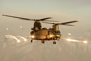 An RAF Chinook helicopter in silhouette, flying over Afghanistan An RAF Chinook helicopter in silhouette, flying over Afghanistan