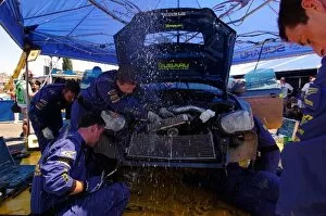 Images Dated 26th June 2004: FIA World Rally Championship: Subaru mechanics repair radiator damage to the Subaru Impreza of
