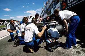 Images Dated 17th February 2004: Formula One World Championship: The Ligier mechanics work on the rear of Jacques Laffites JS7
