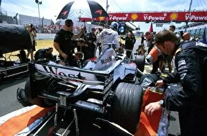 Images Dated 30th June 2003: Formula One World Championship: Mechanics work on the McLaren Mercedes MP4-17D of pole sitter Kimi