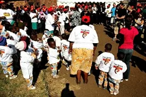 Images Dated 7th August 2004: Unite Against Hunger: Dannii Minogue joins in a dance with children at a school in Soweto which is