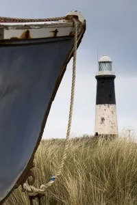 Abandoned Boat And Lighthouse, Humberside, England Abandoned Boat And Lighthouse, Humberside, England