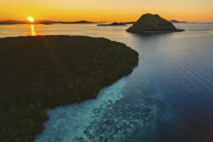 Aerial view of silhouetted islands, Komodo National Park at sunset, Lesser Sunda Islands, Indonesia Aerial view of silhouetted islands, Komodo National Park at sunset, Lesser Sunda Islands, Indonesia
