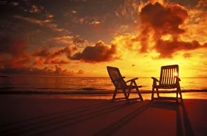 Beach Chairs Along Shoreline At Twilight, Amazing Sunset Beach Chairs Along Shoreline At Twilight, Amazing Sunset