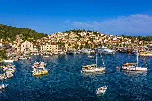 Boats anchored in harbour and marina in front of Old Town of Hvar on Hvar Island, Croatia Boats anchored in harbour and marina in front of Old Town of Hvar on Hvar Island, Croatia